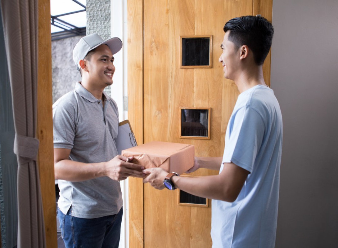 delivery guy handling the package to the customer